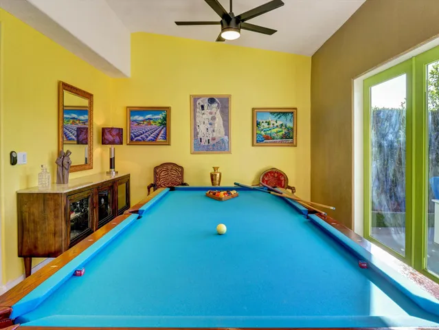 a living room with furniture a flat screen tv and a rug