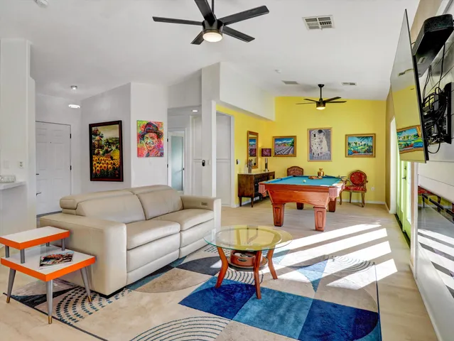 a kitchen with stainless steel appliances granite countertop a stove a sink and white cabinets