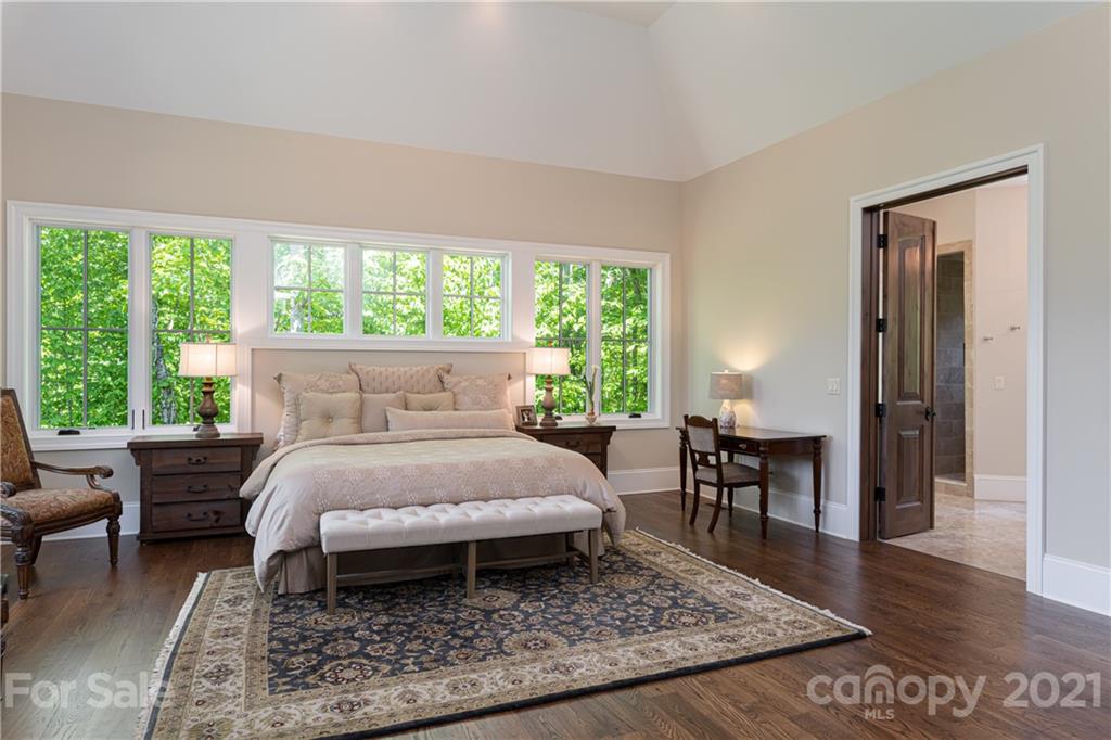 301 Flying Dutchman Road Sylva, NC 28779 - Photo 26 of 48 a bed sitting in a bedroom next to a window with table and chair