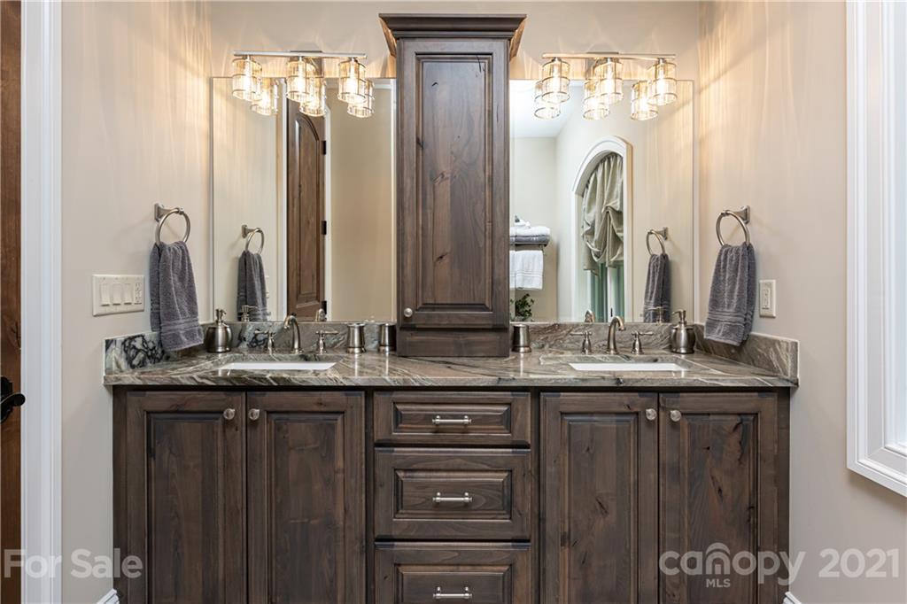 301 Flying Dutchman Road Sylva, NC 28779 - Photo 40 of 48 a bathroom with double sink and a mirror