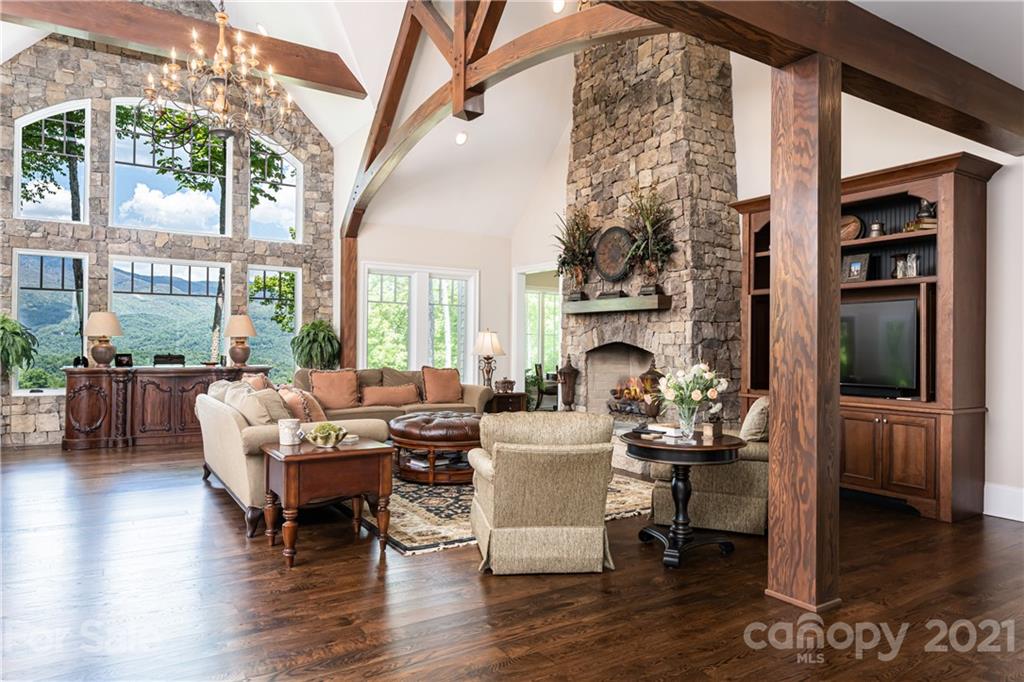 301 Flying Dutchman Road Sylva, NC 28779 - Photo 5 of 48 a living room with furniture a fireplace and a floor to ceiling window