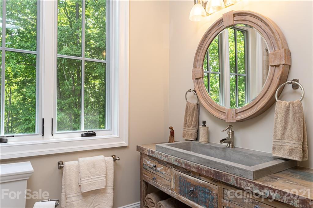 301 Flying Dutchman Road Sylva, NC 28779 - Photo 43 of 48 a bathroom with a sink a mirror and a window