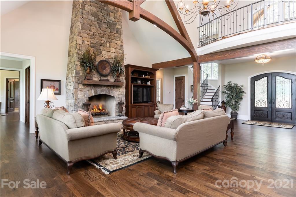 301 Flying Dutchman Road Sylva, NC 28779 - Photo 7 of 48 a living room with furniture a fireplace and a chandelier