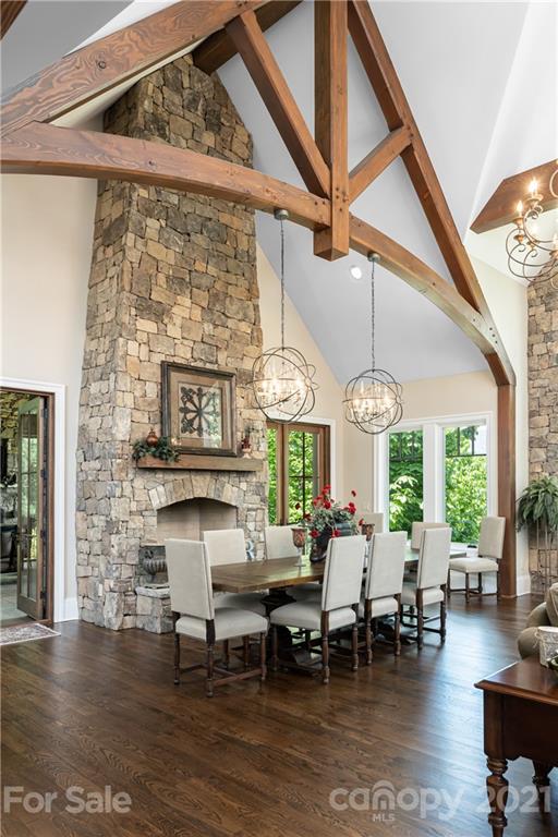 301 Flying Dutchman Road Sylva, NC 28779 - Photo 9 of 48 a living room with couches a large dining table and large window with wooden floor