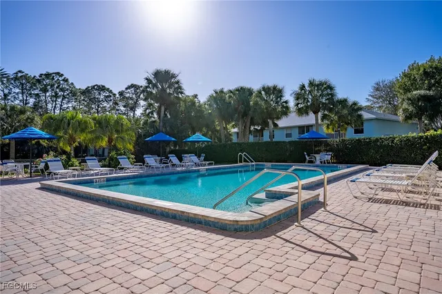 a view of a house with swimming pool and sitting area