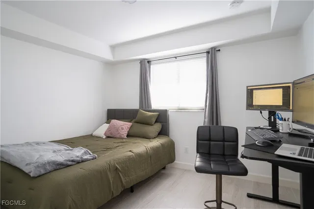 a bathroom with a granite countertop sink toilet and a mirror