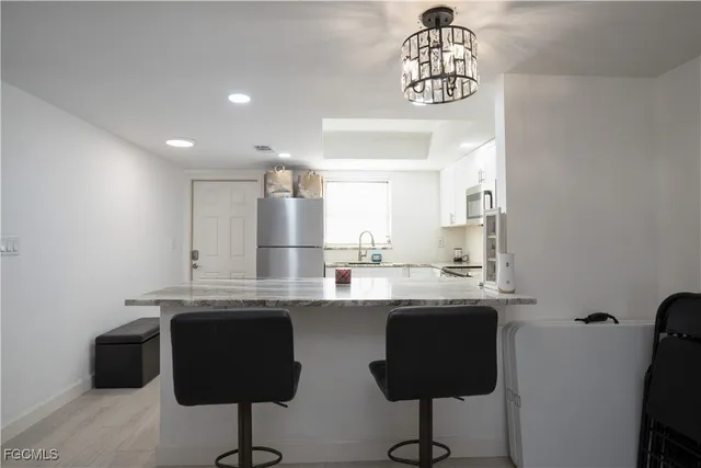 a kitchen with granite countertop a stove sink and cabinets