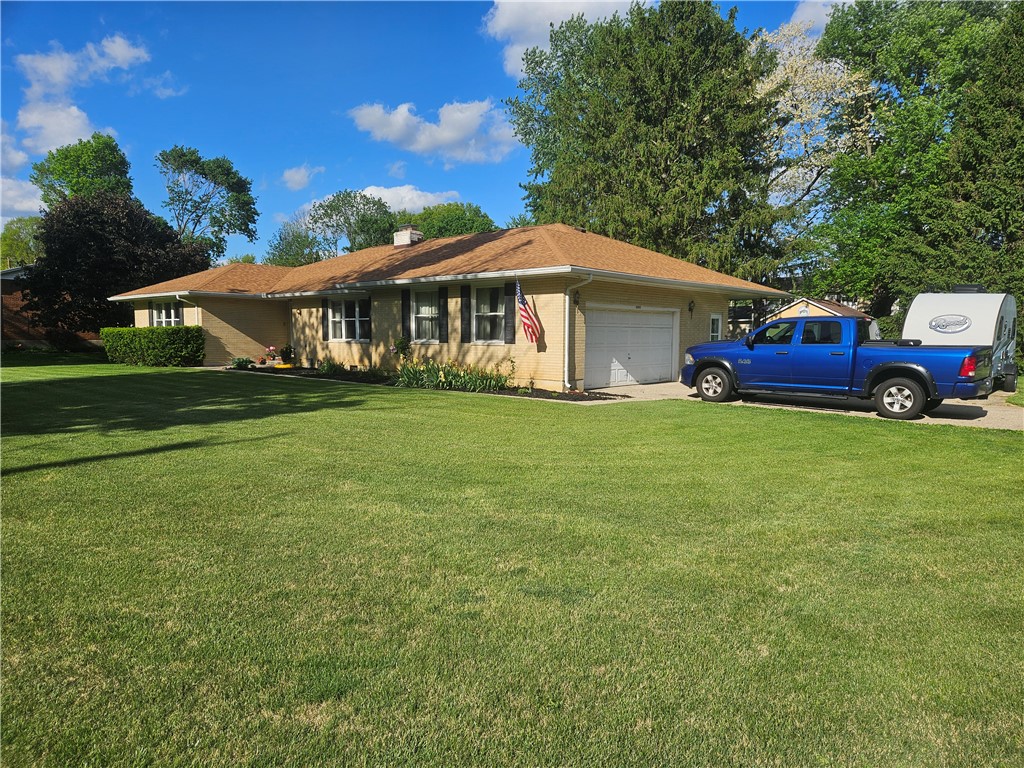 3998 Willowcrest Road Beavercreek, OH 45430 - Photo 2 of 41 This ranch-style home features a well-maintained lawn and an attached garage.