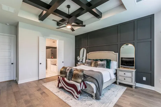 a bedroom with a bed a mirror and a desk