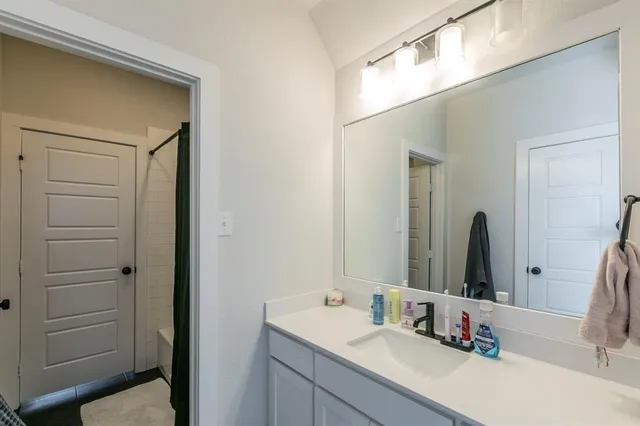 a bathroom with a sink and a mirror