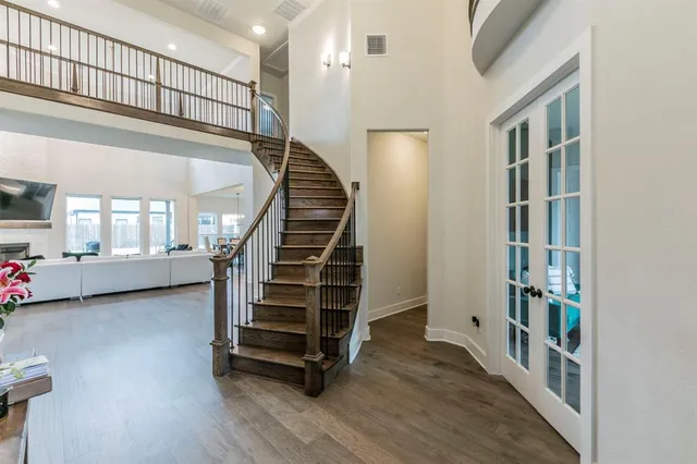 a view of staircase with wooden floor and fan