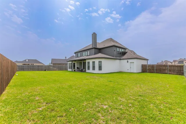 a view of a house with a garden and deck
