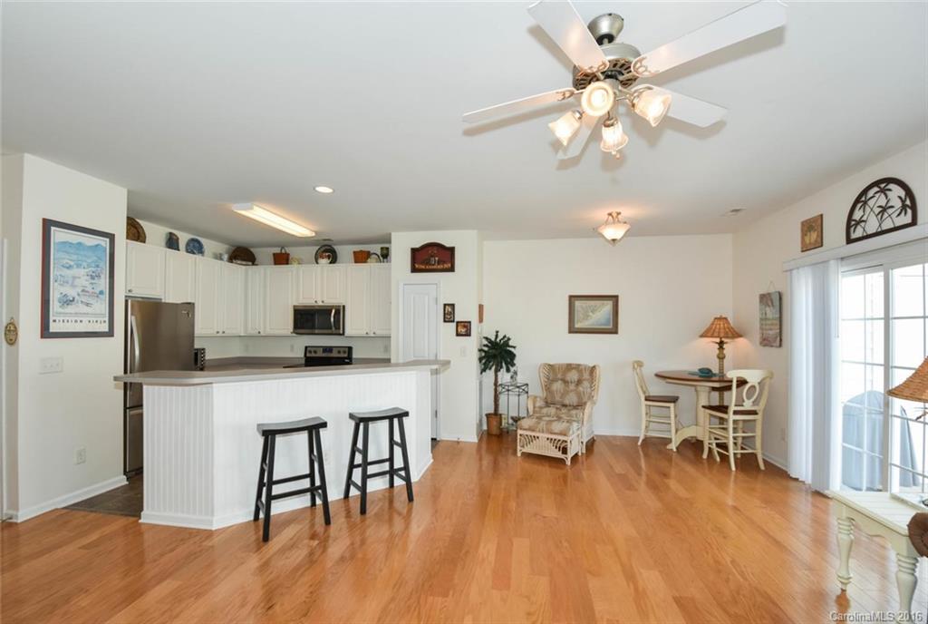 822 Gentlewinds Court, Unit 143 Fort Mill, SC 29708 - Photo 11 of 21 a kitchen with stainless steel appliances a table chairs refrigerator and microwave