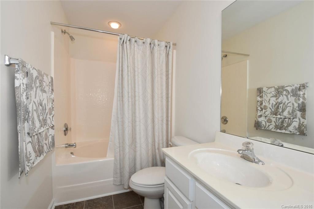 822 Gentlewinds Court, Unit 143 Fort Mill, SC 29708 - Photo 14 of 21 a bathroom with a sink a toilet and shower curtain