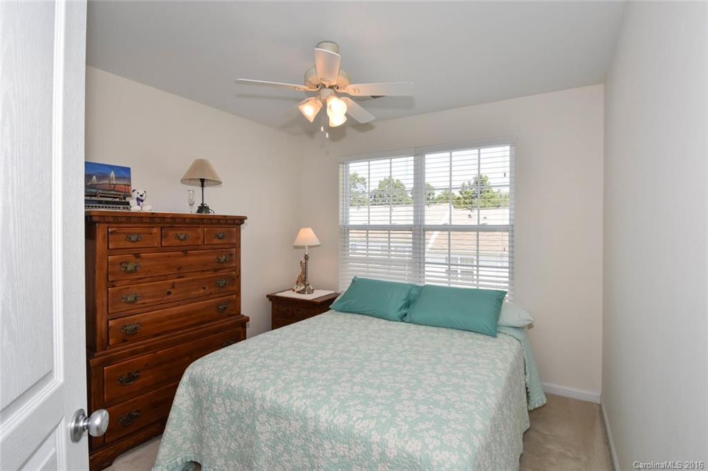 822 Gentlewinds Court, Unit 143 Fort Mill, SC 29708 - Photo 15 of 21 a bedroom with a bed and a chandelier