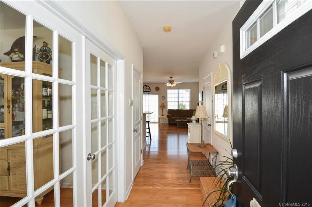 822 Gentlewinds Court, Unit 143 Fort Mill, SC 29708 - Photo 4 of 21 a view of a hallway with wooden floor and living room
