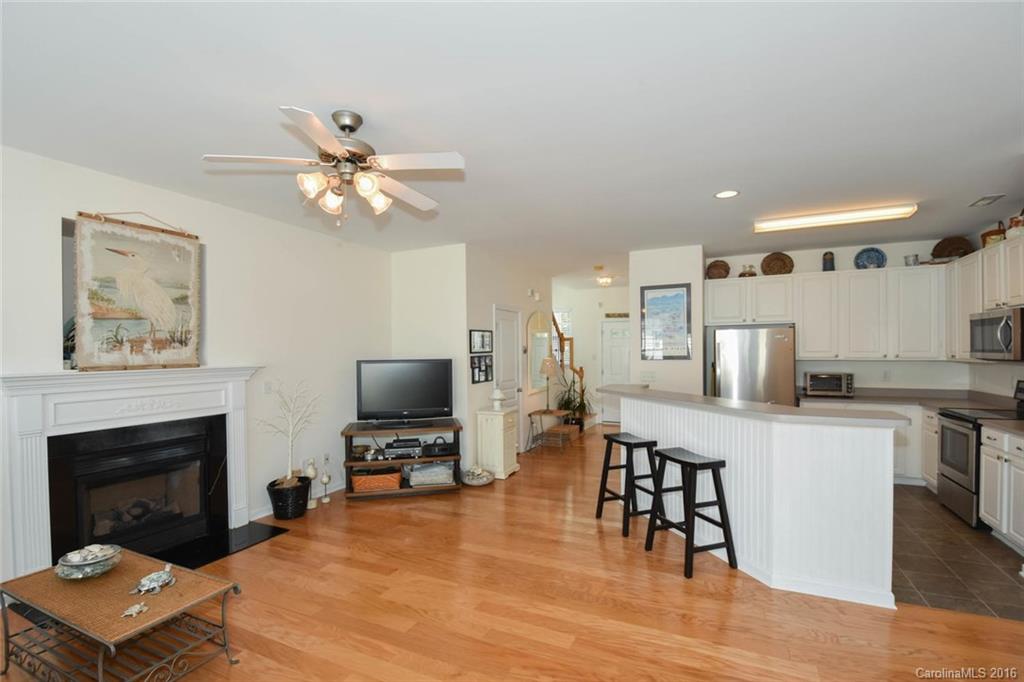 822 Gentlewinds Court, Unit 143 Fort Mill, SC 29708 - Photo 10 of 21 a living room with furniture a fireplace and a flat screen tv