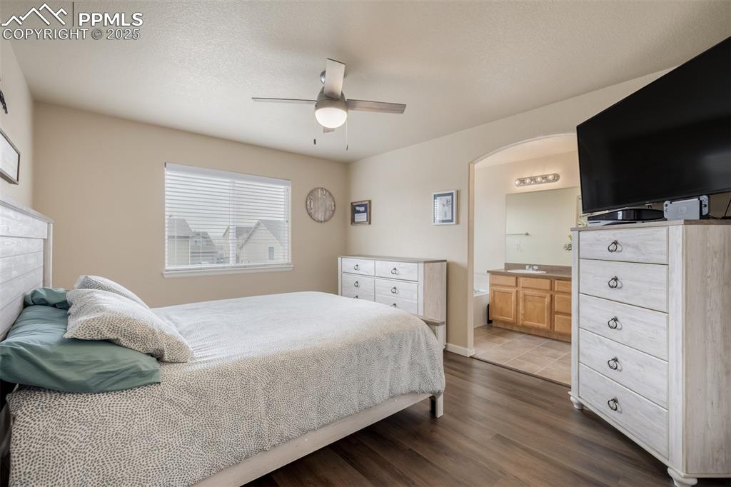 4966 Spokane Way Colorado Springs, CO 80911 - Photo 12 of 35 a bedroom with a bed and a flat screen tv