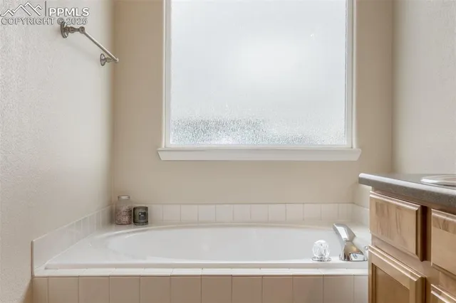 a white bath tub sitting next to a window