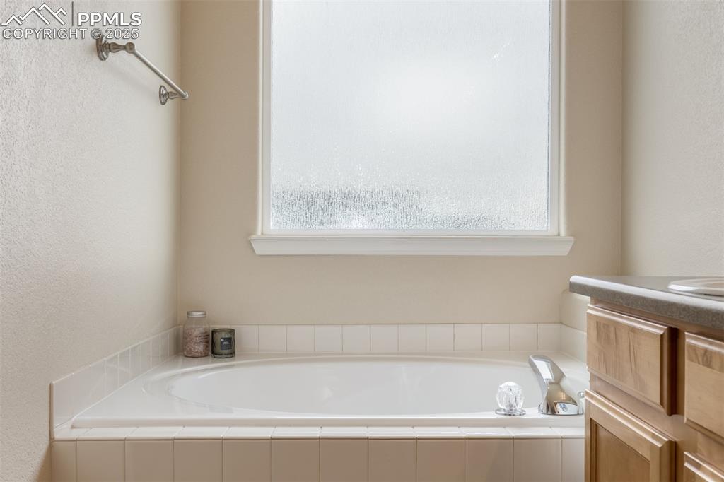 4966 Spokane Way Colorado Springs, CO 80911 - Photo 14 of 35 a white bath tub sitting next to a window