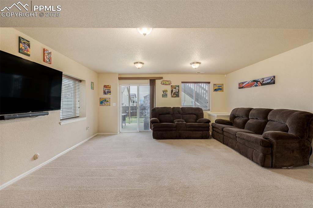 4966 Spokane Way Colorado Springs, CO 80911 - Photo 20 of 35 a living room with furniture and a flat screen tv