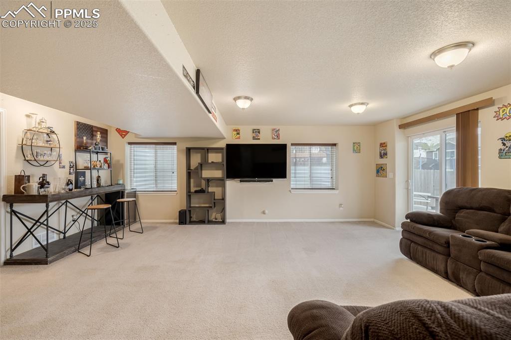 4966 Spokane Way Colorado Springs, CO 80911 - Photo 21 of 35 a living room with furniture and a flat screen tv