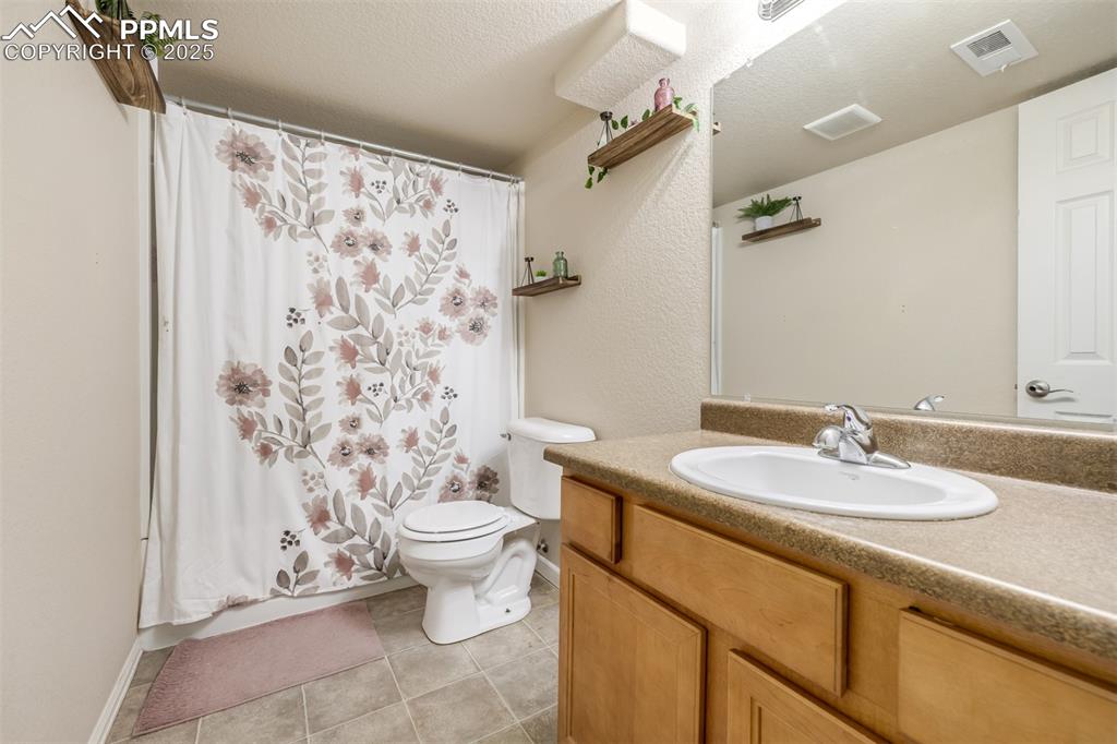 4966 Spokane Way Colorado Springs, CO 80911 - Photo 24 of 35 a bathroom with a sink toilet and shower