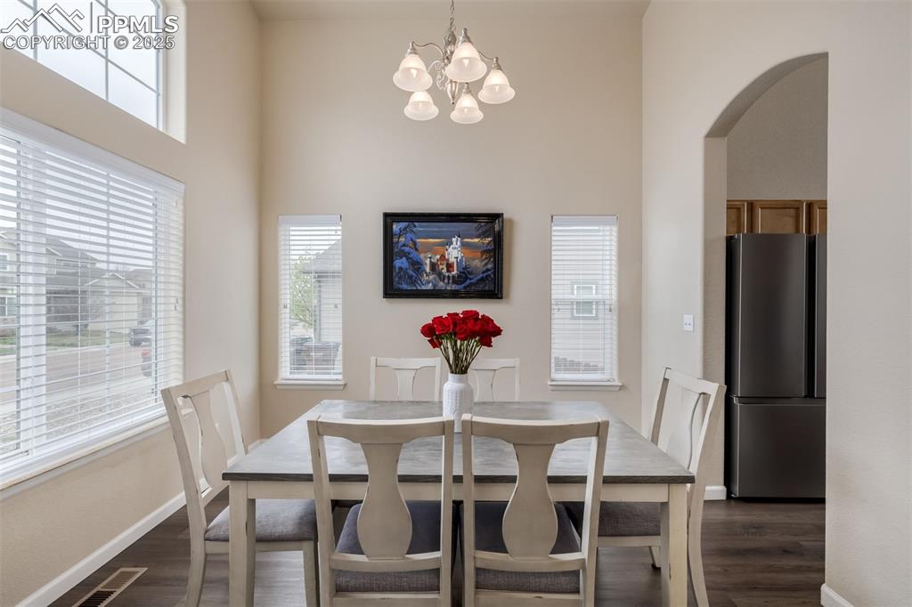 4966 Spokane Way Colorado Springs, CO 80911 - Photo 3 of 35 a view of a dining room with furniture wooden floor and chandelier