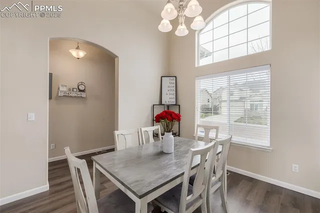 a view of a dining room with furniture wooden floor and chandelier
