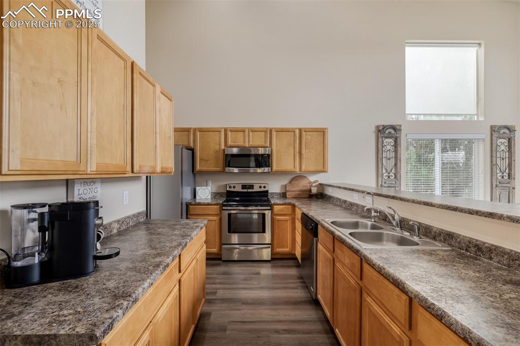 4966 Spokane Way Colorado Springs, CO 80911 - Photo 9 of 35 a large kitchen with stainless steel appliances granite countertop a stove a sink and a granite counter tops