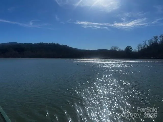 a view of mountain with sunset in background