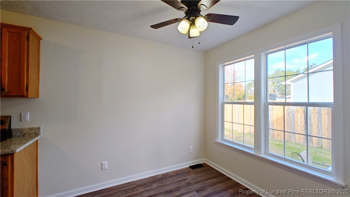 704 South Bethel Road Raeford, NC 28376 - Photo 11 of 32 a view of an empty room with a window and wooden floor