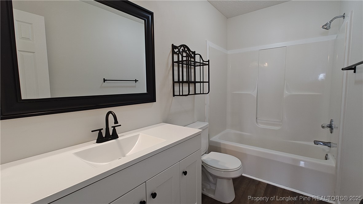 704 South Bethel Road Raeford, NC 28376 - Photo 22 of 32 a bathroom with a sink a toilet and shower