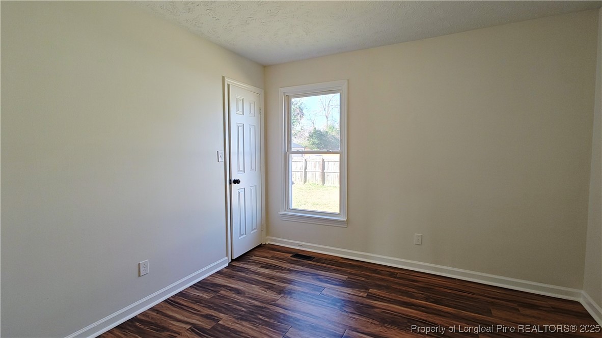 704 South Bethel Road Raeford, NC 28376 - Photo 24 of 32 a view of an empty room with wooden floor and a window