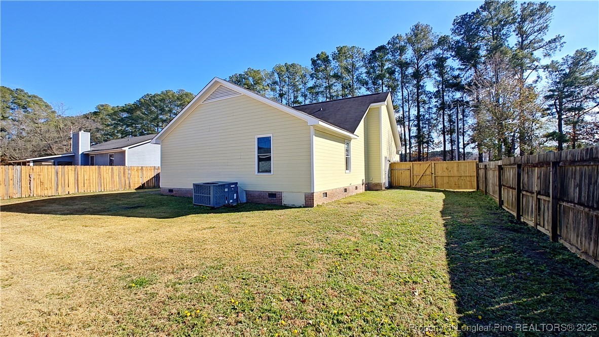 704 South Bethel Road Raeford, NC 28376 - Photo 27 of 32 a view of a house with backyard and tree
