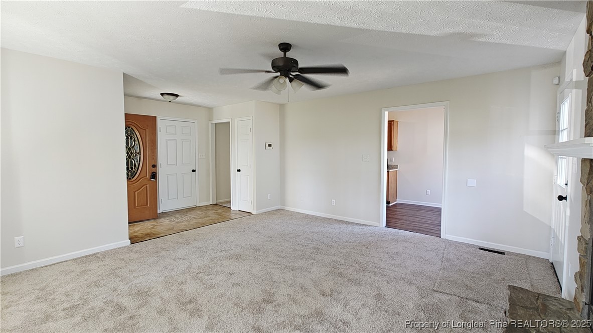 704 South Bethel Road Raeford, NC 28376 - Photo 4 of 32 a view of empty room with a ceiling fan
