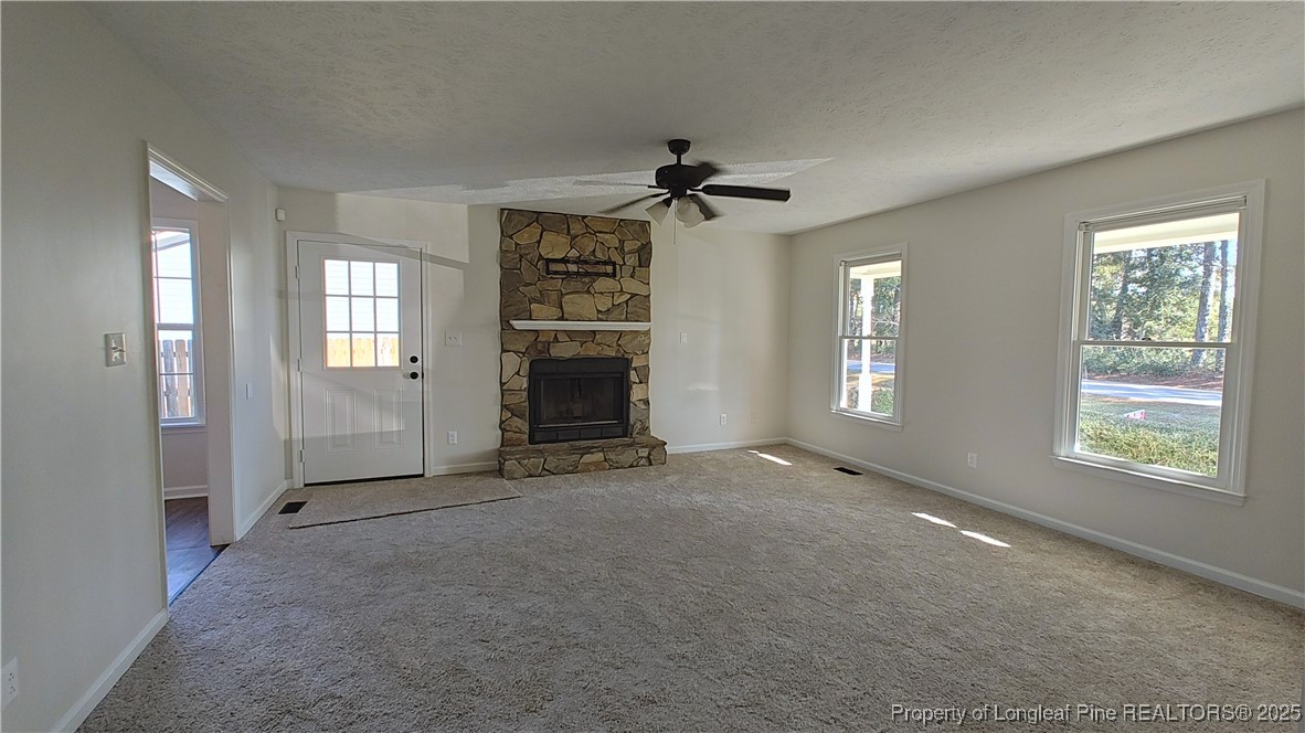 704 South Bethel Road Raeford, NC 28376 - Photo 7 of 32 a view of an empty room with a window and a fireplace