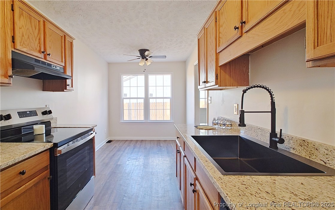 704 South Bethel Road Raeford, NC 28376 - Photo 9 of 32 a kitchen with granite countertop a sink a counter space appliances and cabinets