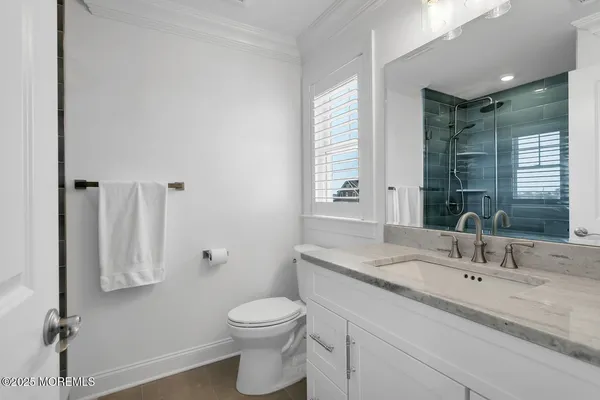 an aerial view of multiple houses with a lake view