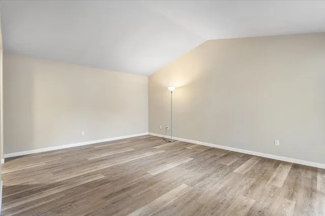 a view of an empty room and wooden floor