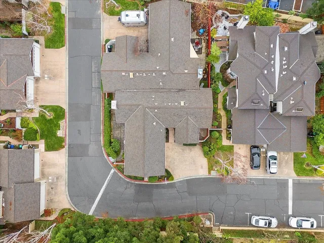 an aerial view of a house with yard and sign board