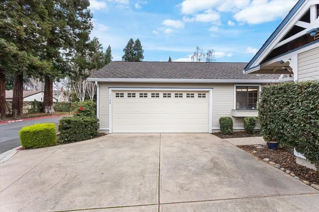 a view of a house with a yard and garage