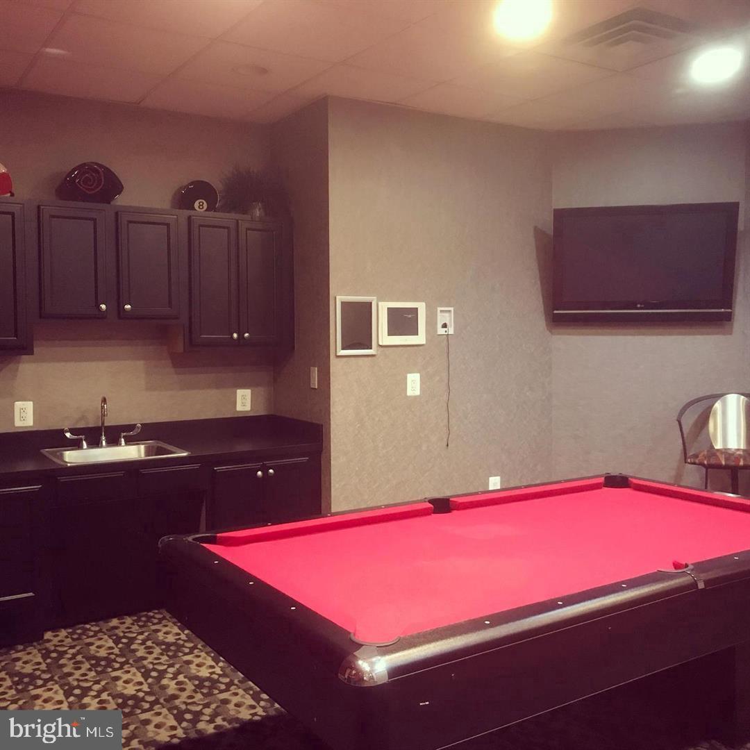 1220 Blair Mill Road, Unit 1007 Silver Spring, MD 20910 - Photo 24 of 27 a bedroom with a bed and a lamp