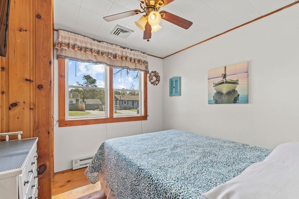 17 Wixon Road Dennis, MA 02639 - Photo 17 of 25 a bedroom with a bed and a chandelier