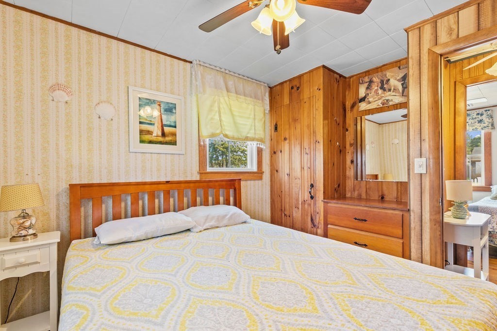 17 Wixon Road Dennis, MA 02639 - Photo 20 of 25 a bedroom with a bed and a chandelier