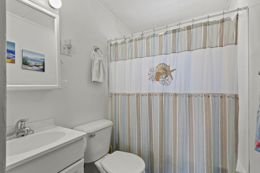 17 Wixon Road Dennis, MA 02639 - Photo 24 of 25 a bathroom with a sink a toilet and a mirror