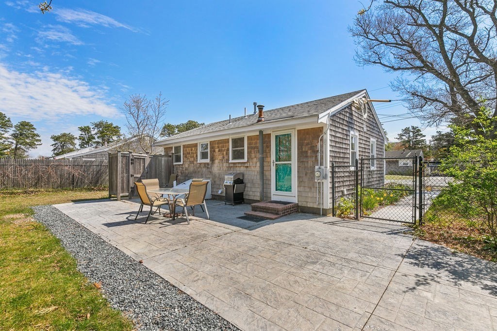 17 Wixon Road Dennis, MA 02639 - Photo 5 of 25 a view of a house with backyard and sitting area