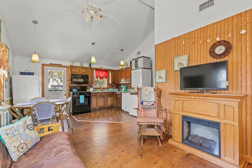 17 Wixon Road Dennis, MA 02639 - Photo 9 of 25 a living room with furniture a flat screen tv and kitchen view