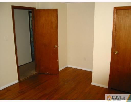 24 Stockton Road New Brunswick, NJ 08901 - Photo 9 of 10 an empty room with wooden floor