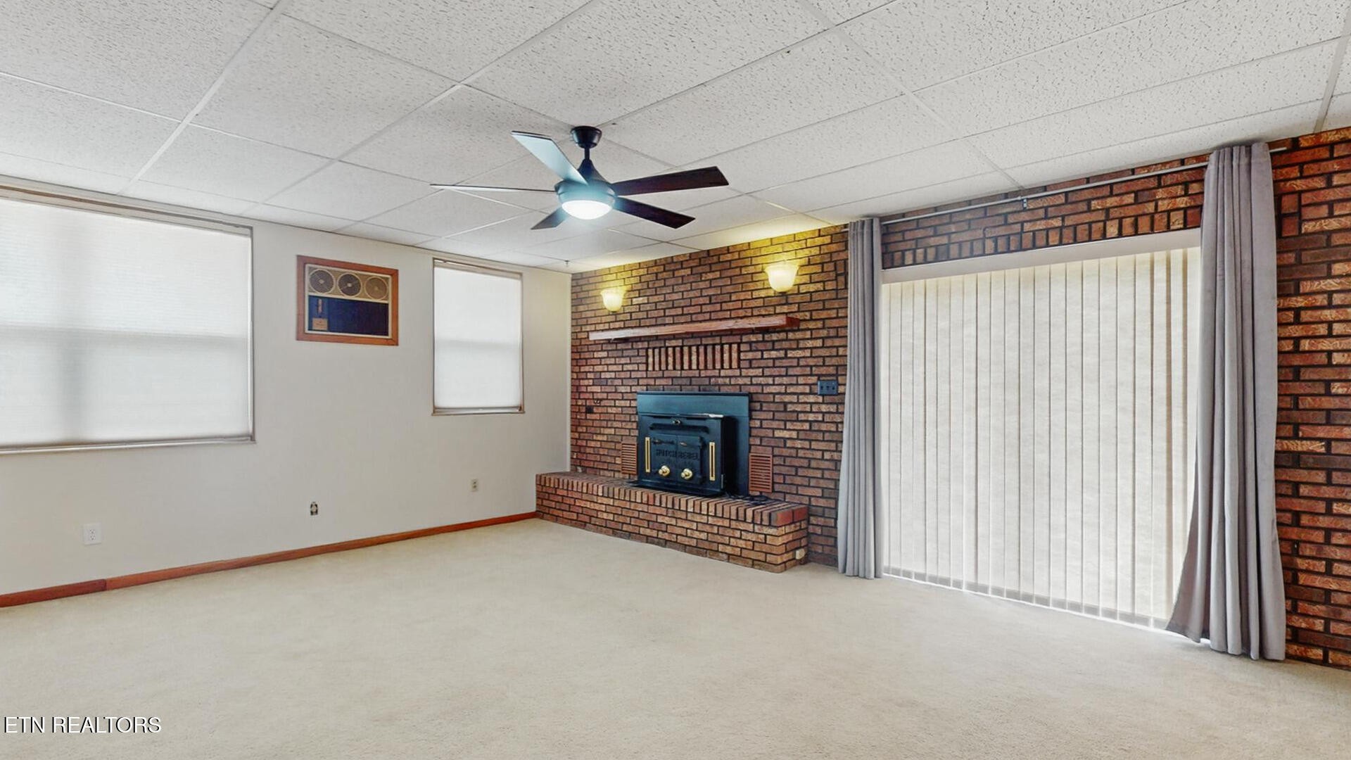 4004 Deerfield Road Knoxville, TN 37921 - Photo 11 of 34 an empty room with a fireplace and window